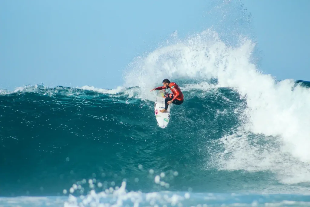 Surfer performing a cutback turn on a wave while maintaining speed and control