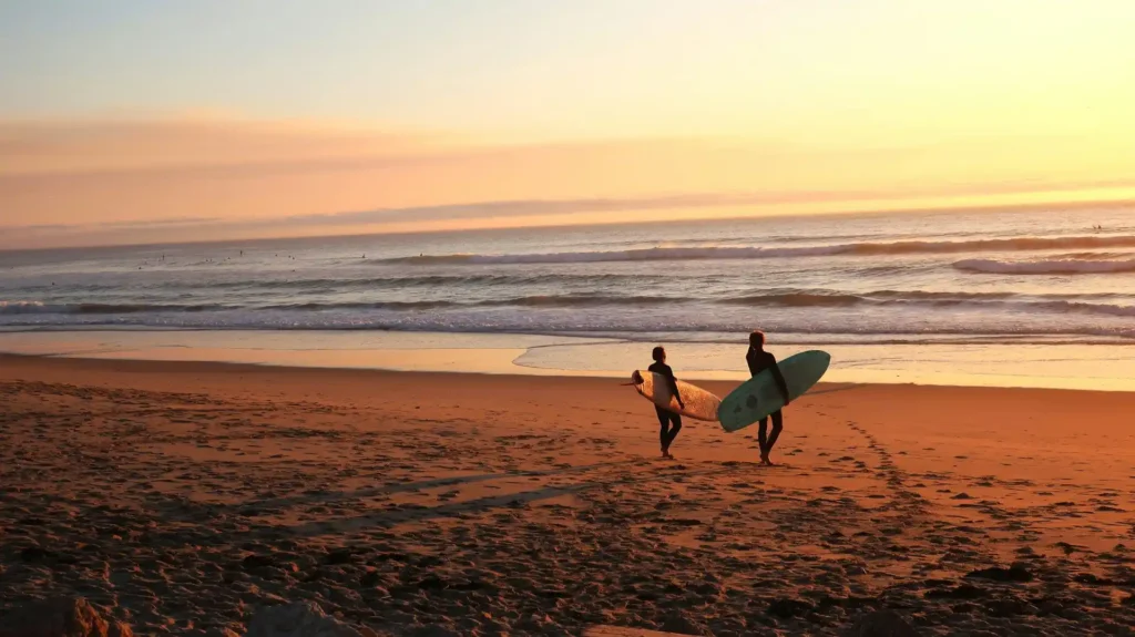 Surfing silhouette during an orange sunset at a surf spot in Bali